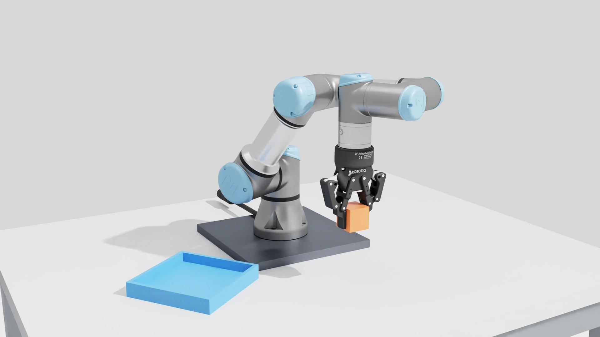 UR3e carrying the orange cube in the integrated Robotiq gripper during transfer.